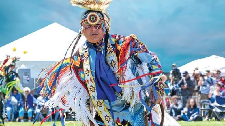 Cass Rudolph dancing at a Na-Me-Res Powwow with traditional Indigenous attire