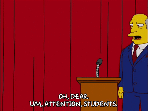 a GIF from "The Simpsons" showing Superintendent Chalmers speaking at the podium at a school assembly