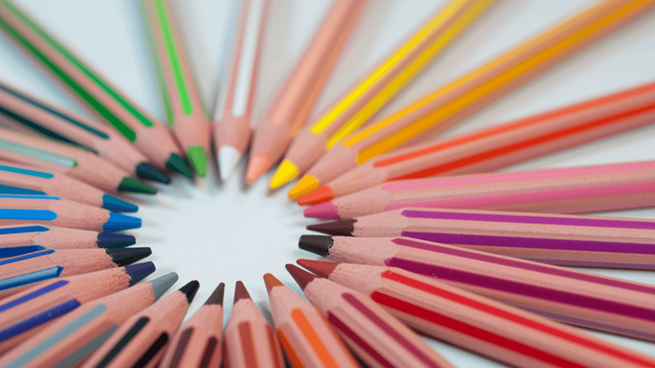 pencil crayons arranged in a circle with their sharpened ends pointing toward the centre