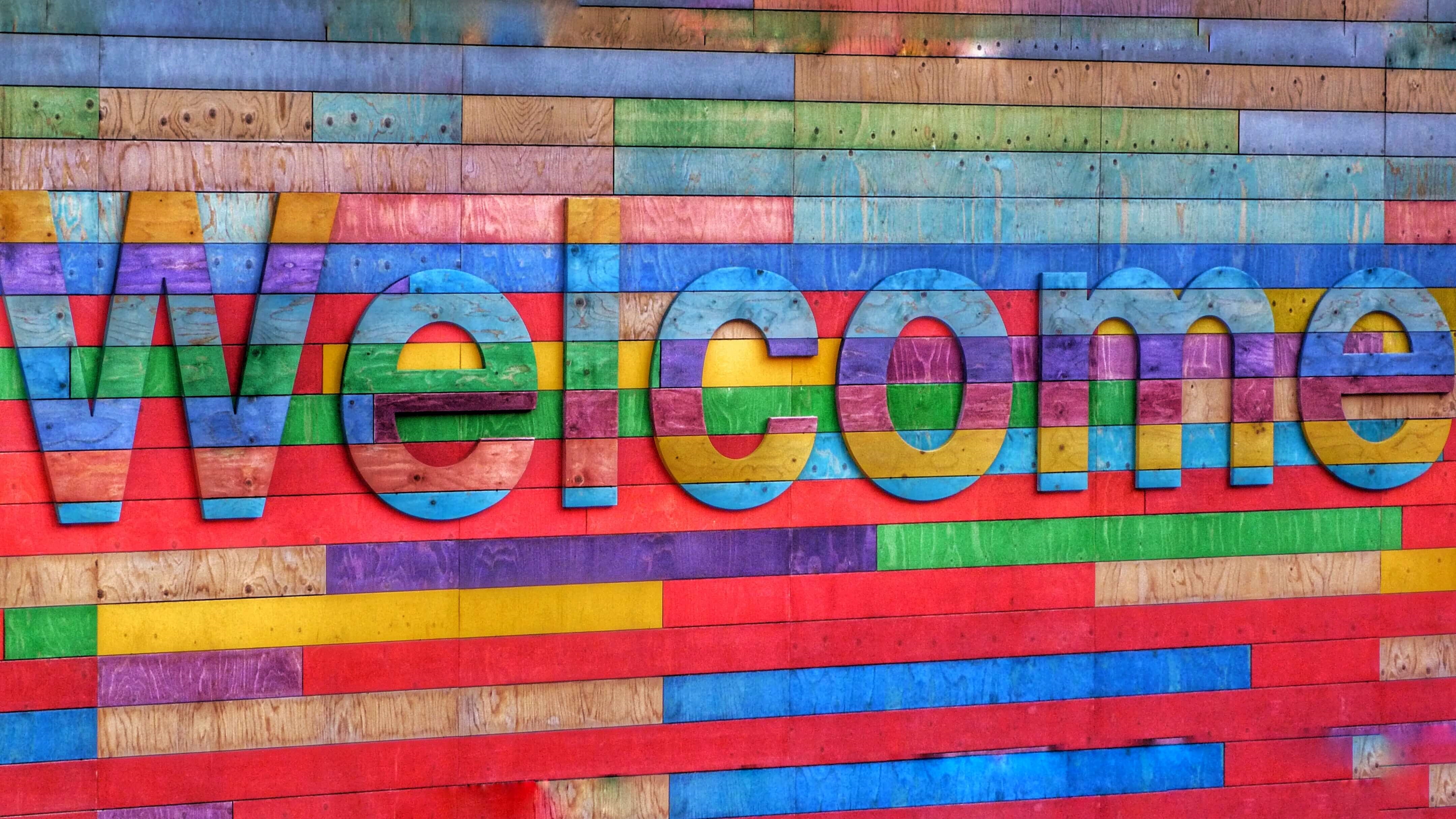 A colourful brick wall that says "Welcome"