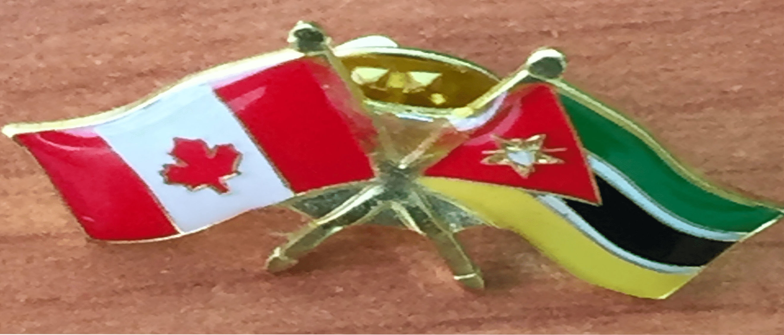 A pin depicting the flags of Canada and Mozambique side-by-side