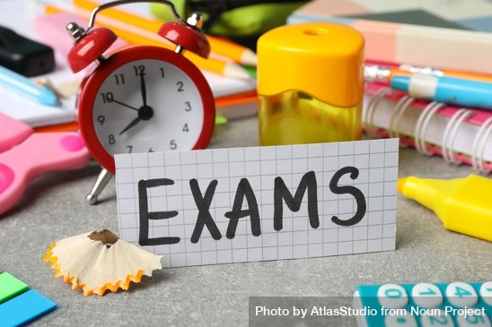 The word “Exams” surrounded by clock and stationary on desk by AtlasStudio from <a href="https://thenounproject.com/photo/the-word-exams-surrounded-by-clock-and-stationary-on-desk-bEjnl0/" target="_blank" title="The word “Exams” surrounded by clock and stationary on desk Photo